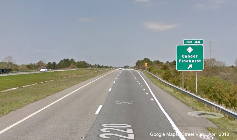 Google Maps Street View image of ground mounted exit sign for NC 211 on I-73/US 220 North, 
        I-74 West in Candor in April 2018