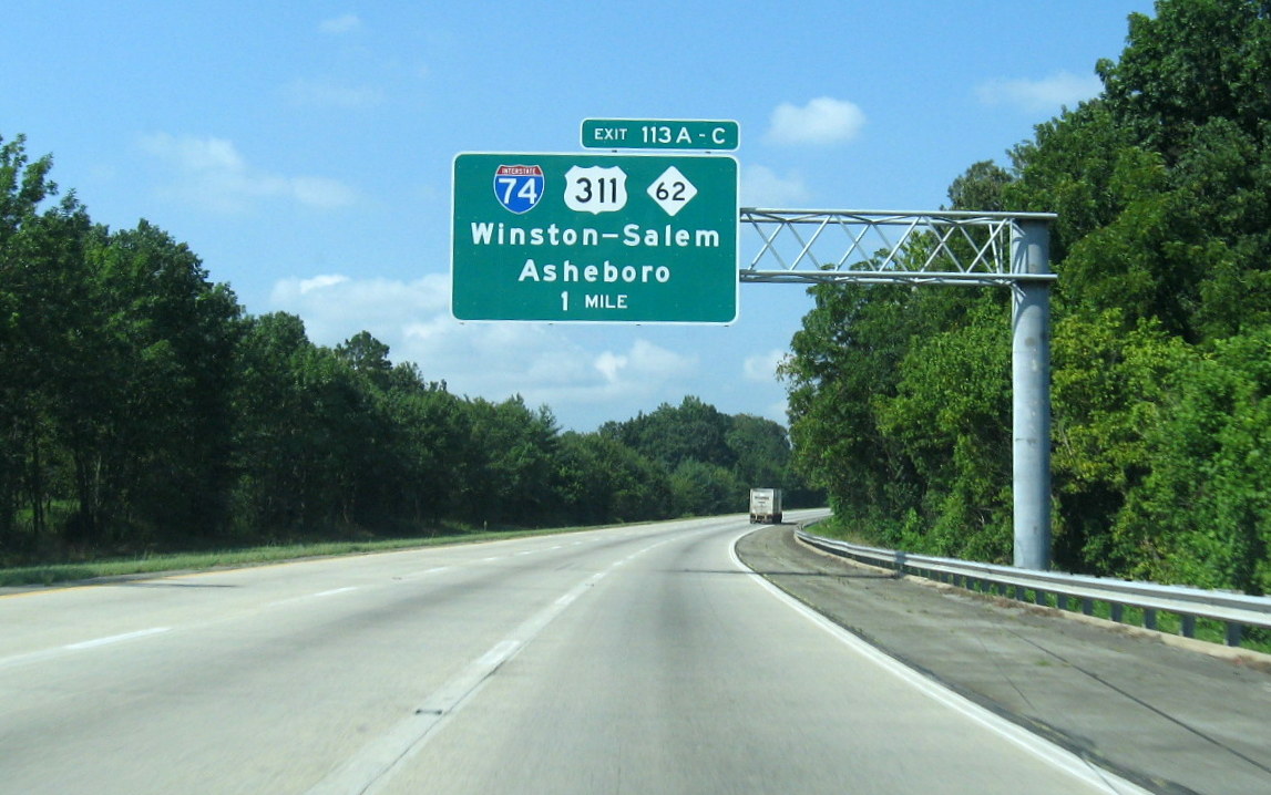 Photo showing I-85 overhead exit signs for the unopened I-74 interchange in 
Oct. 2010