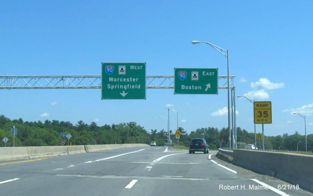 Image of recently placed overhead signs for I-90/Mass Pike West and East ramps from MA 30 in Natick