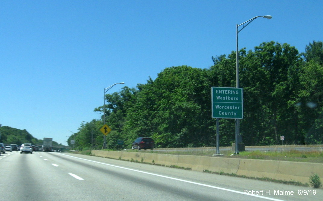 Image of recently placed ground mounted jurisdictional boundary sign for both Westboro and Worcester County on I-90/Mass Pike West