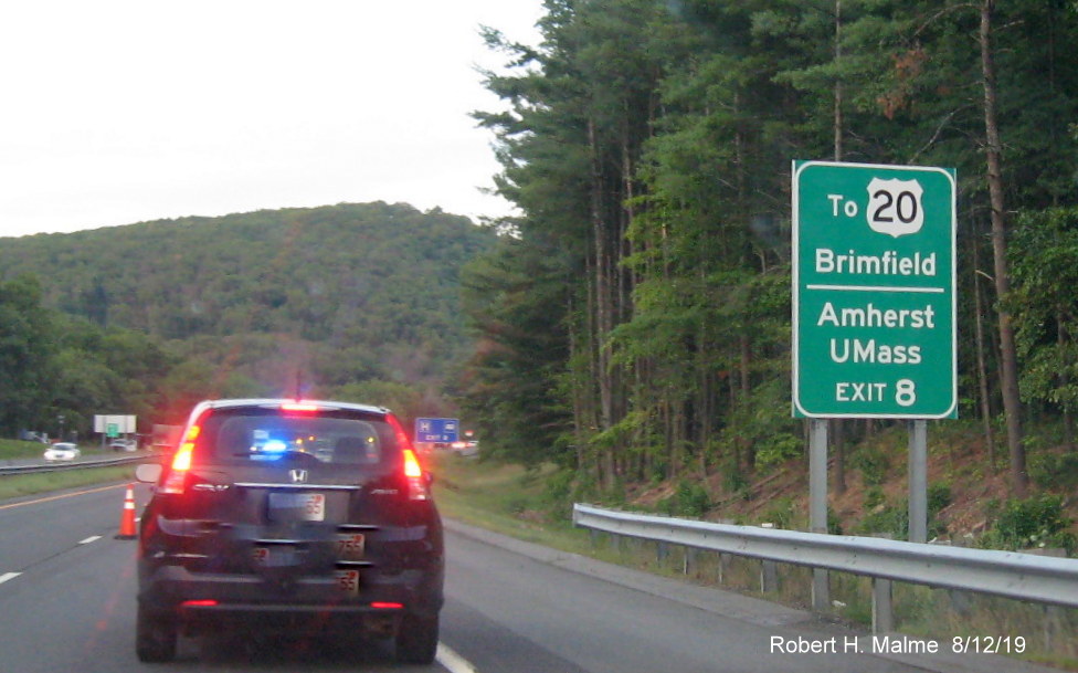 Image of US 20 Brimfield/UMass Amherst auxiliary sign for MA 21 Palmer exit on I-90/Mass Pike East in Aug. 2019