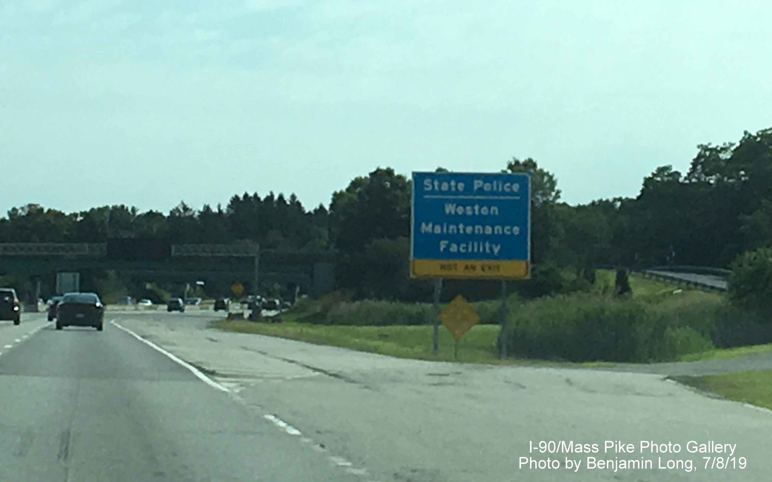 Image of blue entrance sign for Weston State Police Barracks/Maintenance Facility on I-90/Mass Pike East, by Benjamin Long