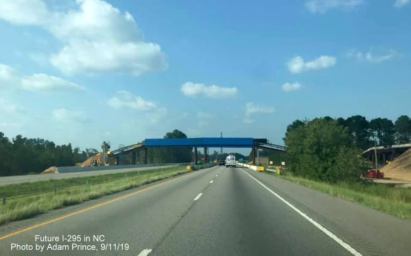Image of conveyor belt built above I-95 lanes to carry dirt excavated for Future 
      I-295 interchange near St Pauls, NC., by Adam Prince