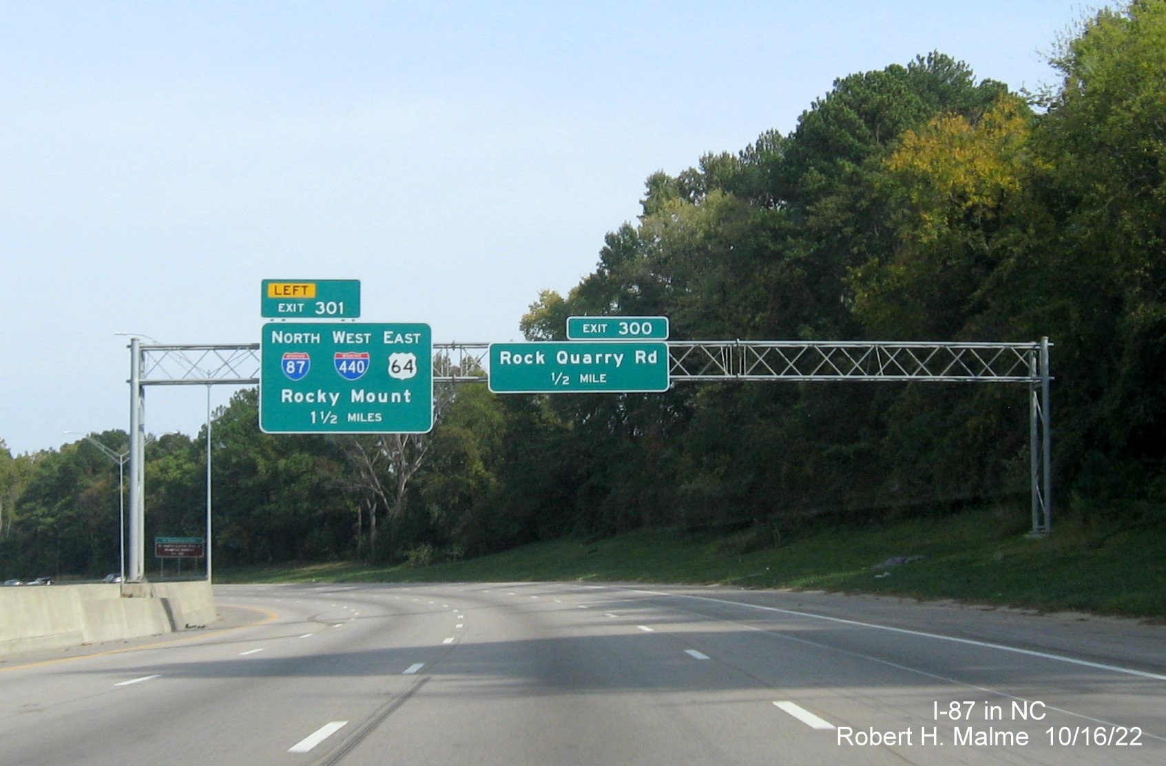 Image of 1 1/2 Miles advance overhead sign for I-87 North/I-440 West/US 64 East on I-40/US 64 East 
                                        in Raleigh, October 2022