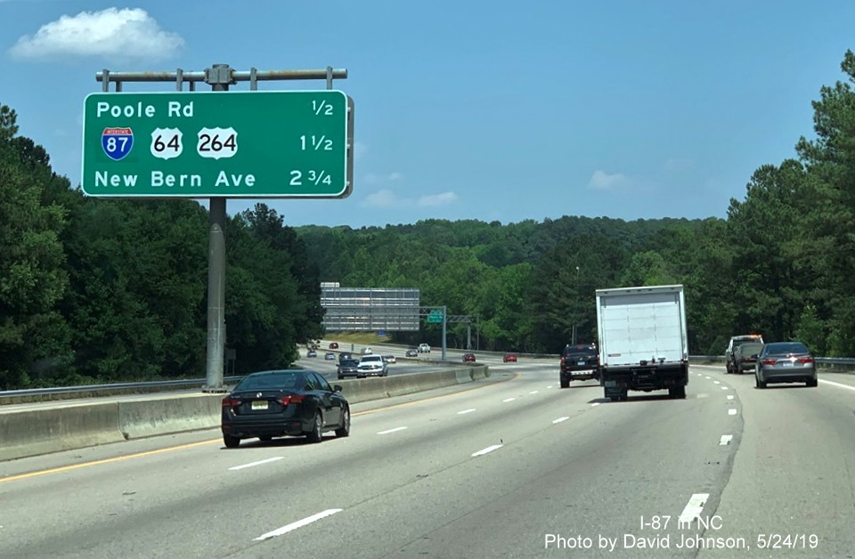 Image of overhead median interchange distance sign with new I-87 shield covering over I-495 shield on I-87 NorthI-440 West in Raleigh, by David Johnson