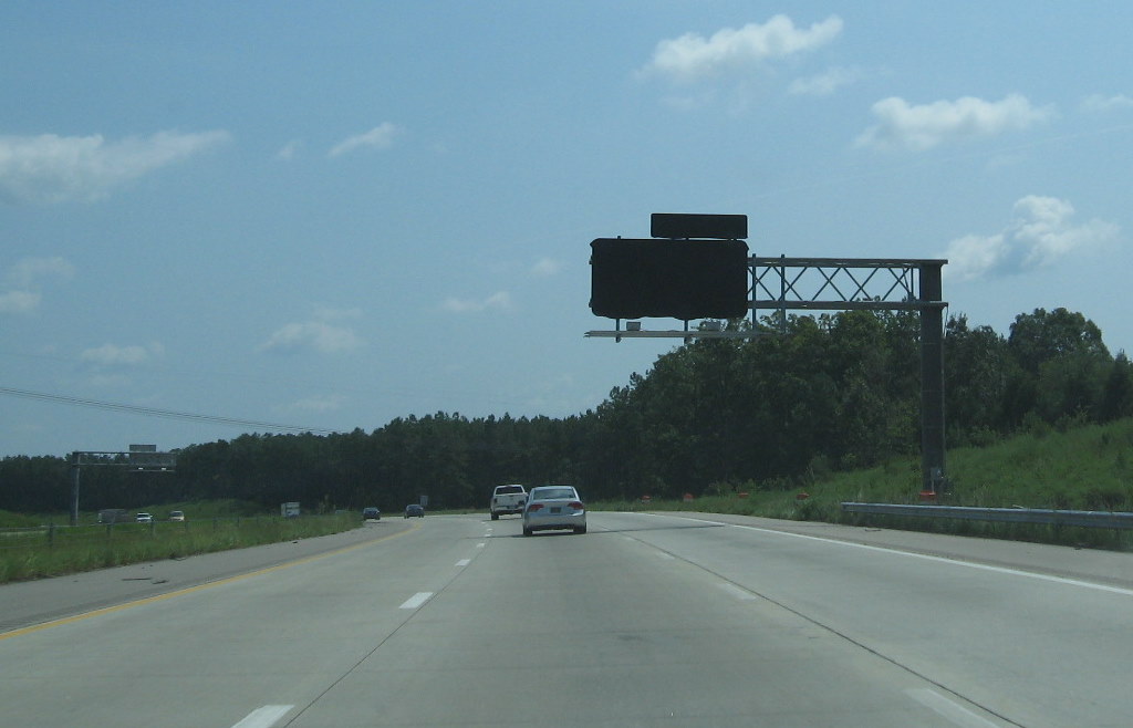 Photo of covered signage for new interchange with US 64/264 
in August 2009