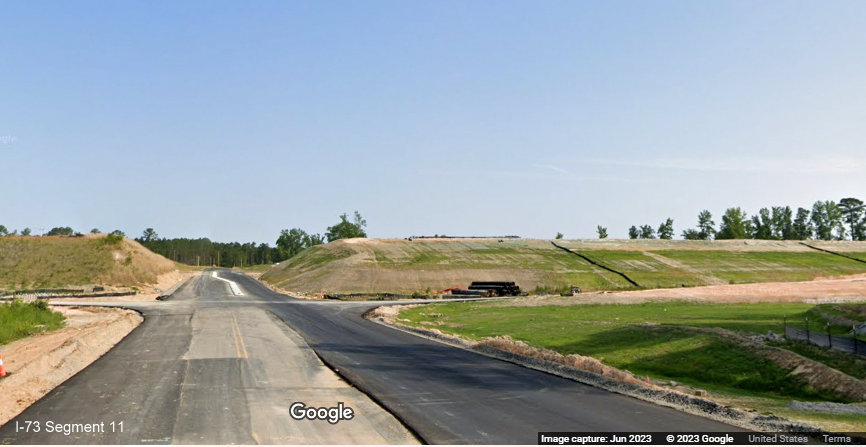 Image of paving started along future exit ramps to I-73/I-74 Rockingham Bypass from Cartledge 
       Creek Road, Google Maps Street View, June 2023