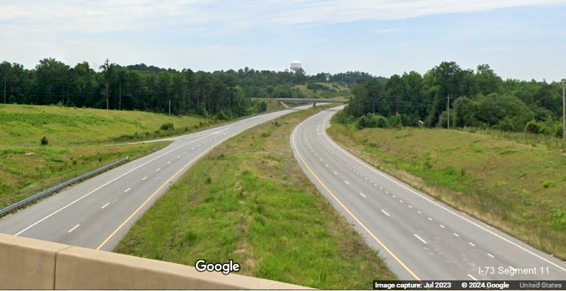 Image of lanes marked along completed northern section of Future I-73/I-74 Rockingham Bypass 
          from US 220 South bridge, Google Maps Street View, July 2023