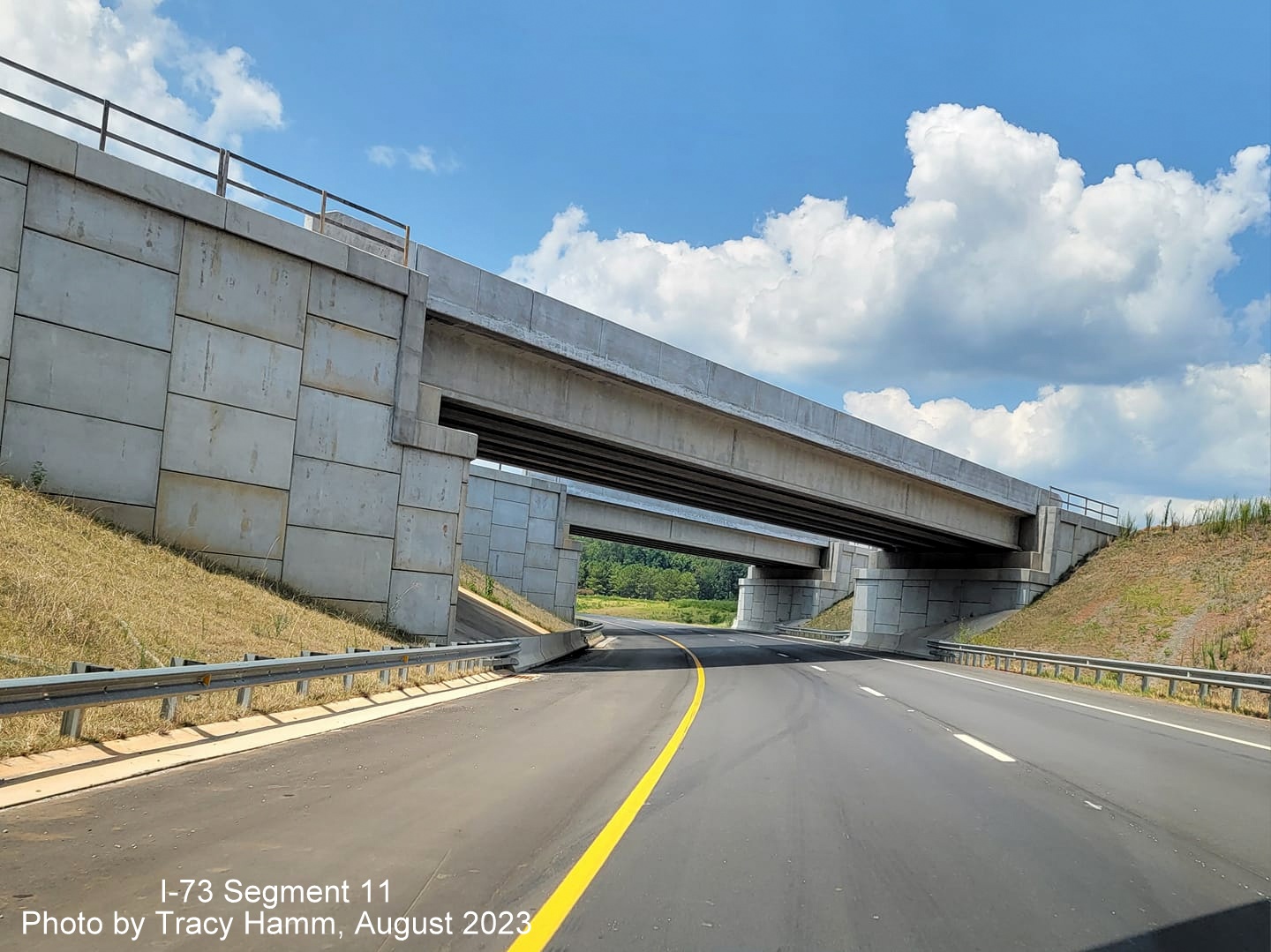 Image of 2-lane US 74 West ramp heading under bridges that will carry the future 
        I-73/I-74 Rockingham Bypass, by Tracy Hamm, August 2023