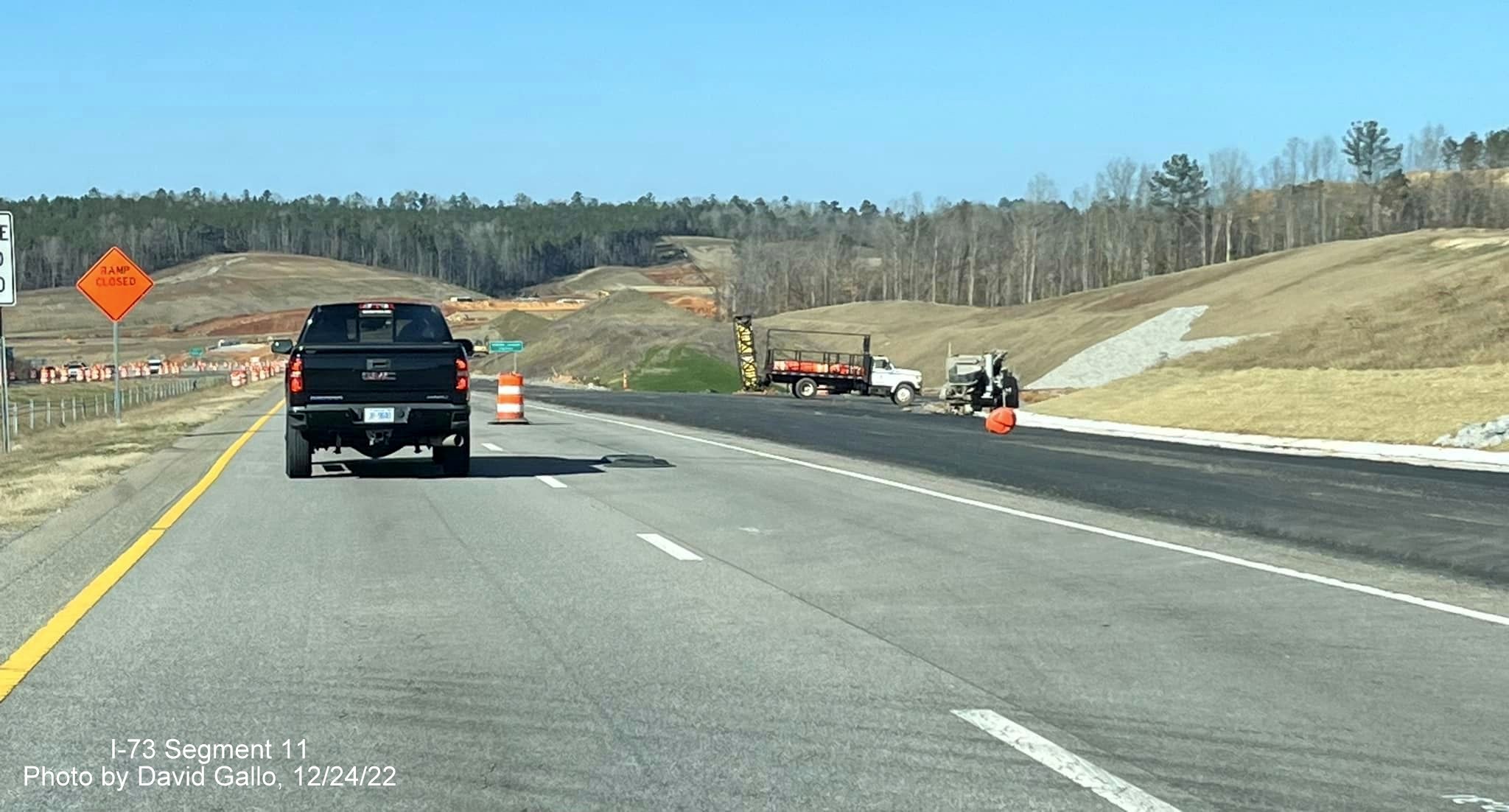 Image of new lane paved along US 74 West approaching I-73/I-74 Bypass construction zone, 
                                            photo by David Gallo, December 2022