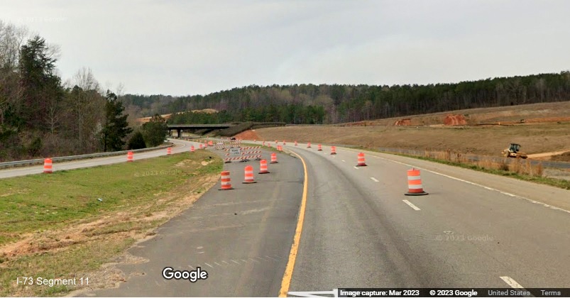 Image of newly created paved crossover for US 74 East traffic to soon to westbound lanes, as part 
        of construction of future I-73/I-74 Rockingham Bypass interchange, Google Maps Street View, March 2023