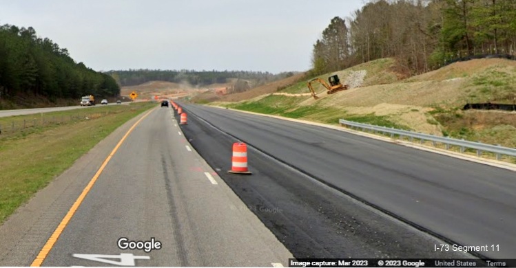 Image of partially paved lanes of US 74 West heading towards at site of future I-73/I-74 
        Rockingham Bypass interchange, Google Maps Street View, March 2023