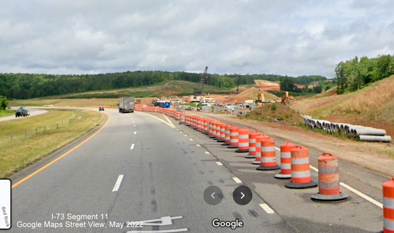 Image from US 74 West of former US 74 Business ramp being used as construction equipment
        storage area for I-73/I-74 Rockingham Bypass, Google Maps Street View, May 2022