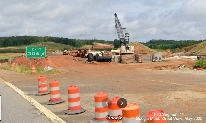 Image of gore sign still standing for closed US 74 Business ramp, now holding construction equipment for
        I-73/I-74 Rockingham Bypass construction, Google Maps Street View, May 2022