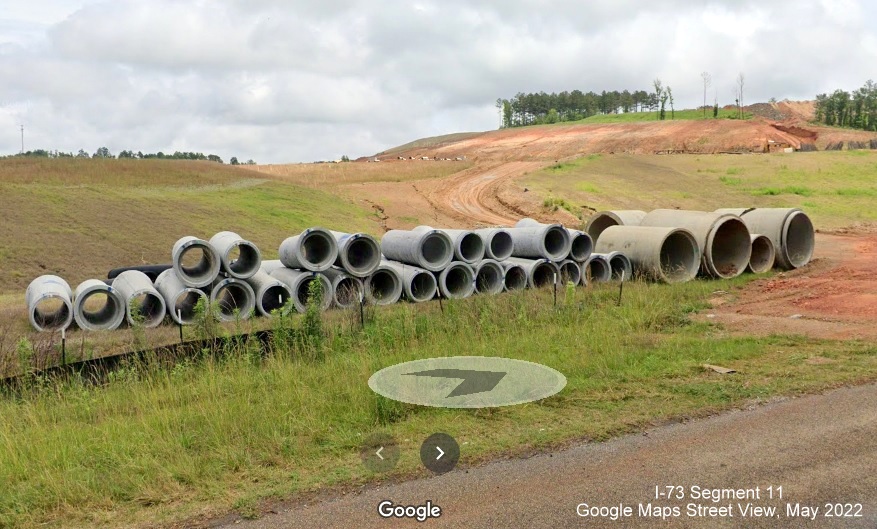 Image of concrete pipes with grading of land for construction of I-73/I-74 Rockingham Bypass beyond from US 74 West, 
        Google Maps Street View, May 2022