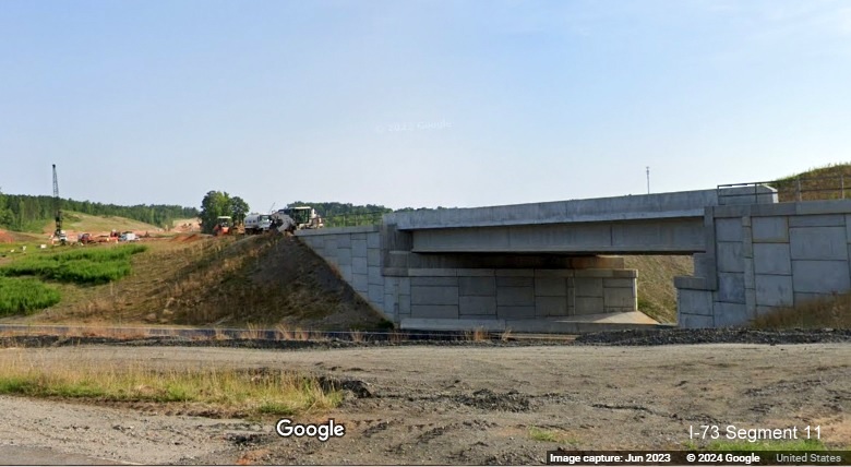 Image of future I-73South/I-74 West bridge under construction over new US 74 West ramp in Rockingham 
        Bypass construction zone, Google Maps Street View, June 2023