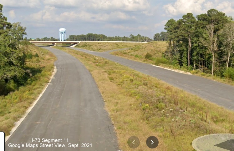 Image of view looking north from Harrington Road bridge over future I-73/I-74 Rockingham 
        Bypass toward ramp to US 220 South, Google Maps Street View image, September 2021