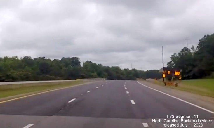 Image of US 74 West now widened to 3 lanes approaching future interchange with I-73/I-74 
       Rockingham Bypass, video from North Carolina Backroads, July 2023