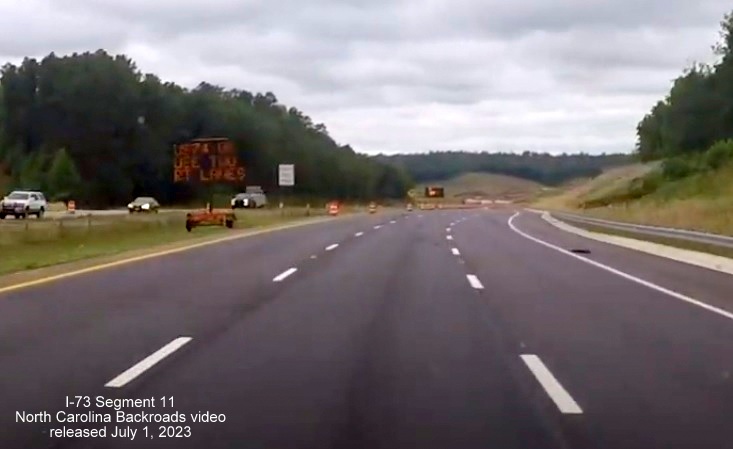 Image of VMS sign US 74 West now widened to 3 lanes approaching future interchange with I-73/I-74 
       Rockingham Bypass, video from North Carolina Backroads, July 2023
