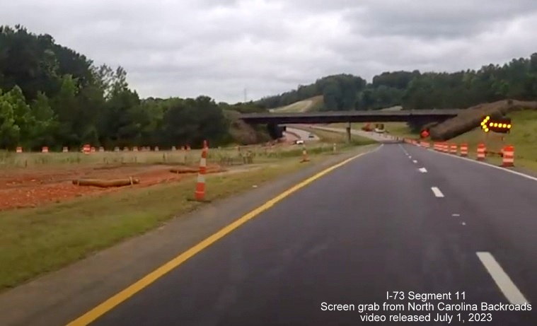 Image of US 74 West traffic returning to old alignment, now removed as part of future interchange with I-73/I-74 
       Rockingham Bypass, video from North Carolina Backroads, July 2023
