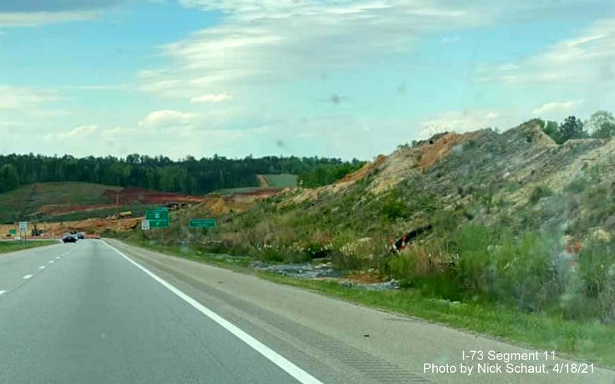 Image of construction along US 74 West approaching closed Business US 74 exit showing constuction of I-73/I-74 Rockingham Bypass 
        construction, by Nick Schaut, April 2021