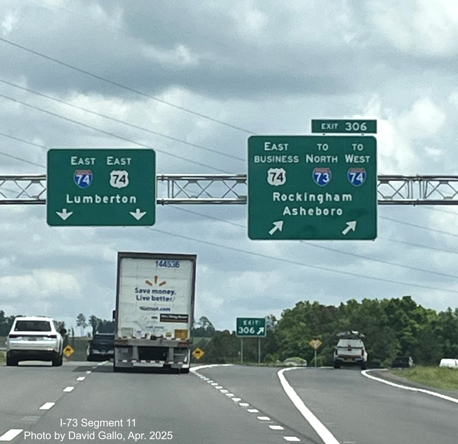 Image of overhead signage on US 74 East at exit for Business 74 and the ramp
		to I-73 North/I-74 West Rockingham Bypass by David Gallo, April 2025