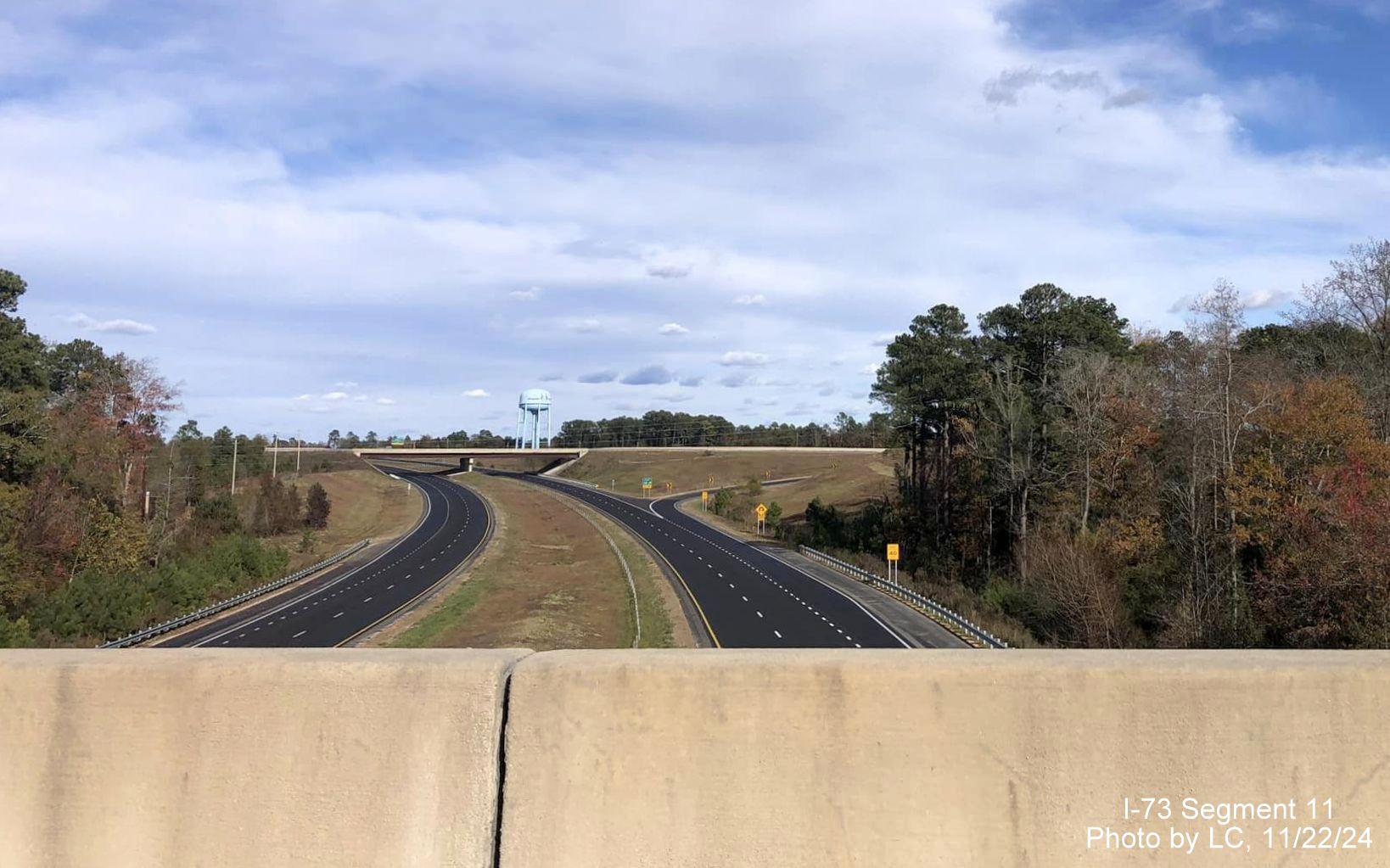 Image of exit ramp for US 220 exit on yet to open I-73 North/I-74 West
        Rockingham Bypass as seen from Harrington Road bridge, by LC, November         2024