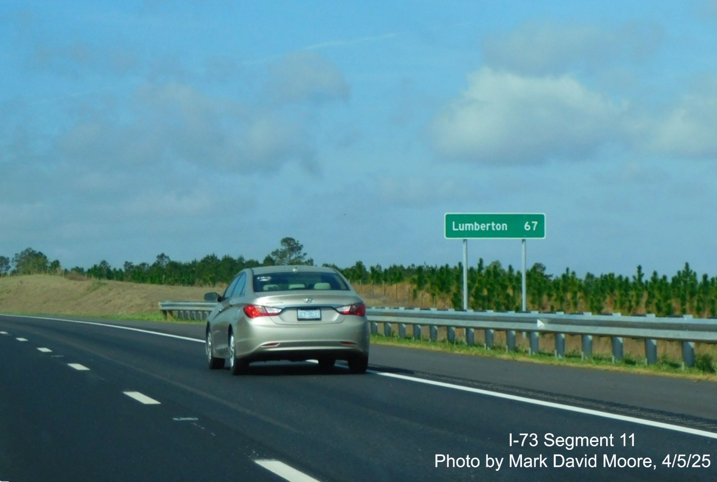 Image of ground mounted distance sign for Lumberton prior to the Cartledge Creek 
		Road exit on I-73 South/I-74 East Rockingham Bypass by Mark David Moore, April 2025