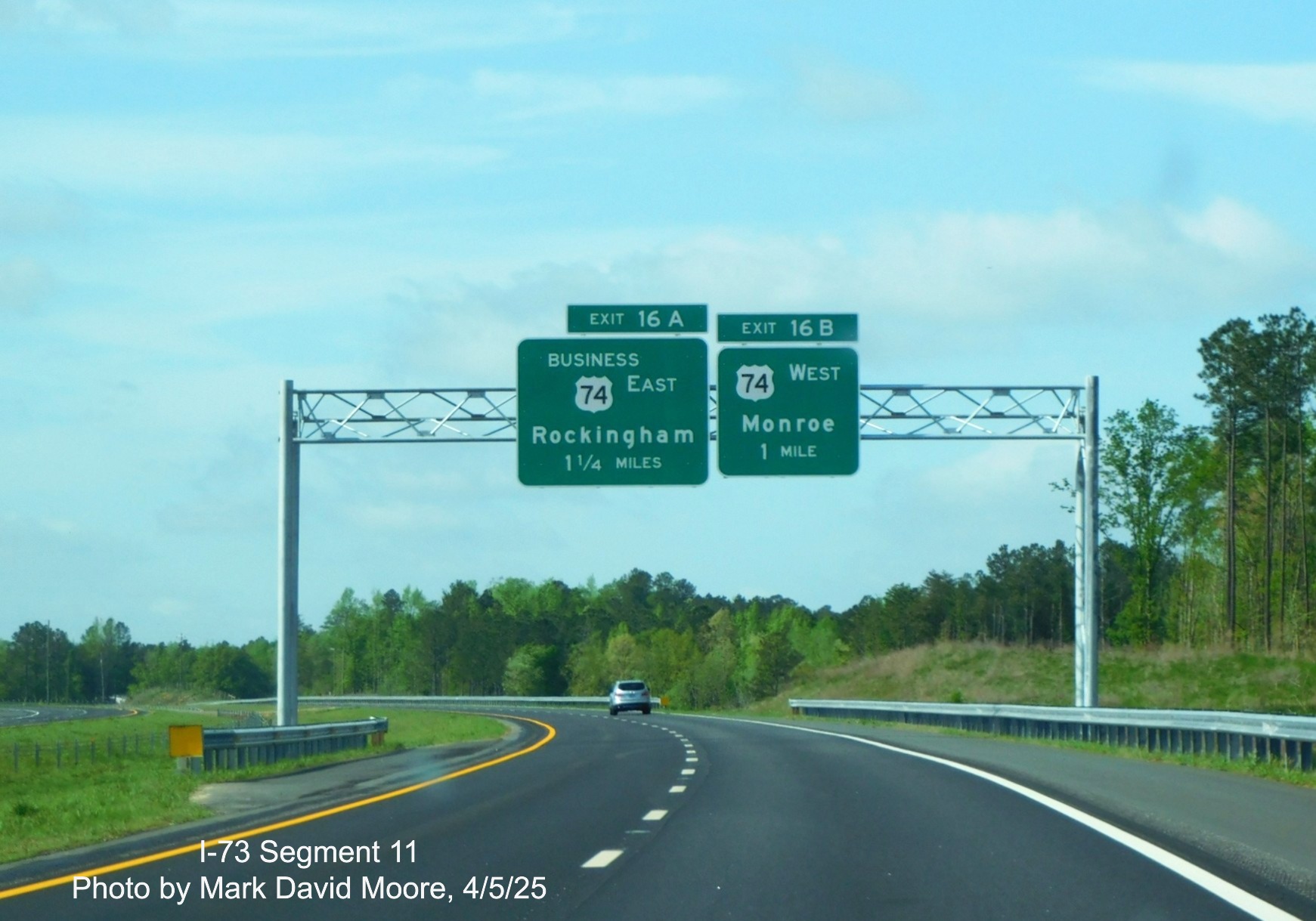 Image of 1 1/4 and 1 mile advance signs for Business 74 and US 74 exits on 
		I-73 South/I-74 East Rockingham Bypass by Mark David Moore, April 2025
