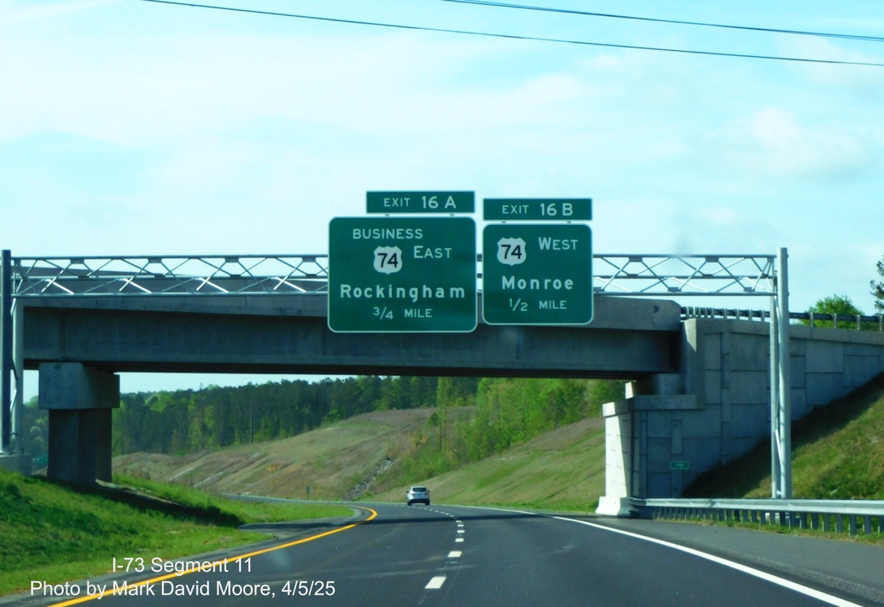 Image of 3/4 and 1/2 mile advance signs for Business 74 and West US 74 exits on 
		I-73 South/I-74 East Rockingham Bypass by Mark David Moore, April 2025