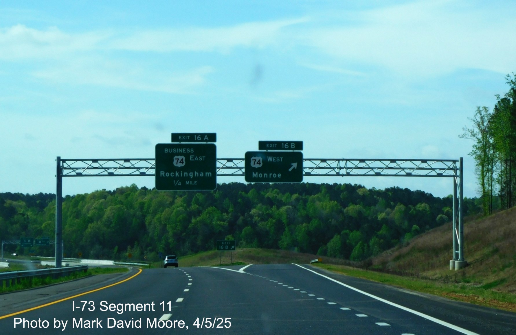 Image of 1/4 advance and ramp signs for Business 74 and West US 74 exits on 
		I-73 South/I-74 East Rockingham Bypass by Mark David Moore, April 2025