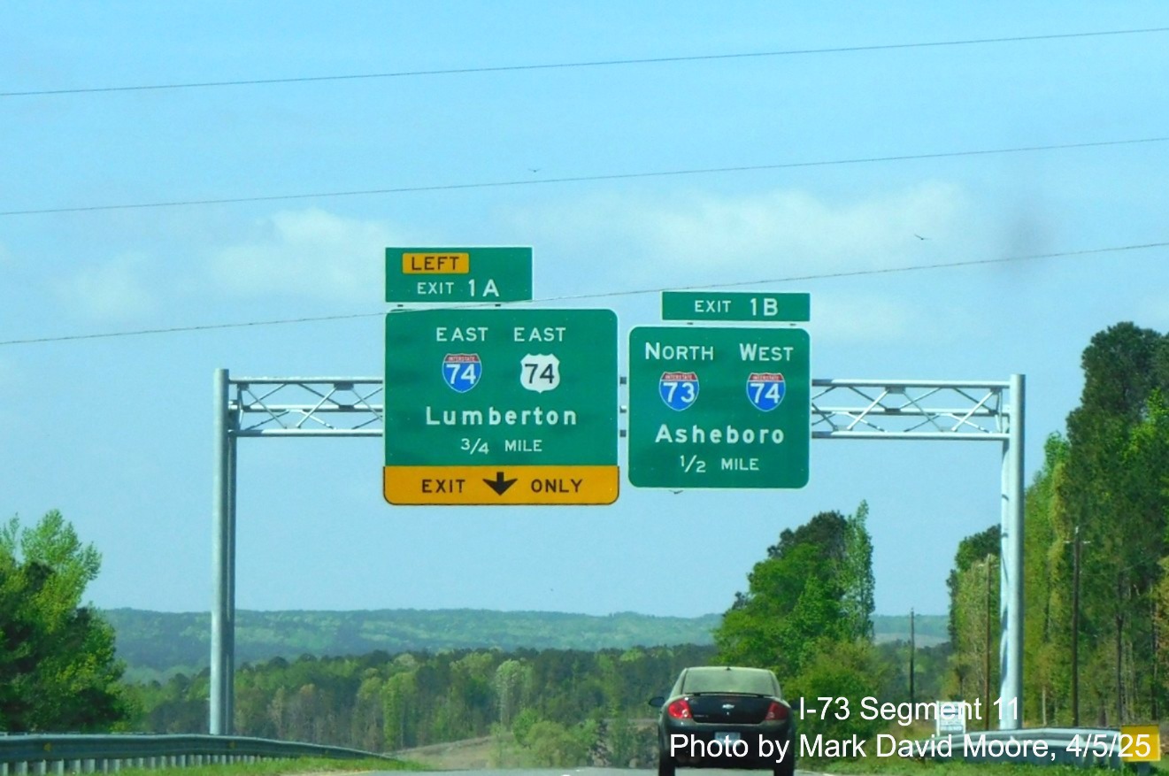 Image of overhead advance signs for I-73/I-74 and I-74/US 74 Rockingham Bypasses
		on US 74 Business West by Mark David Moore, April 2025