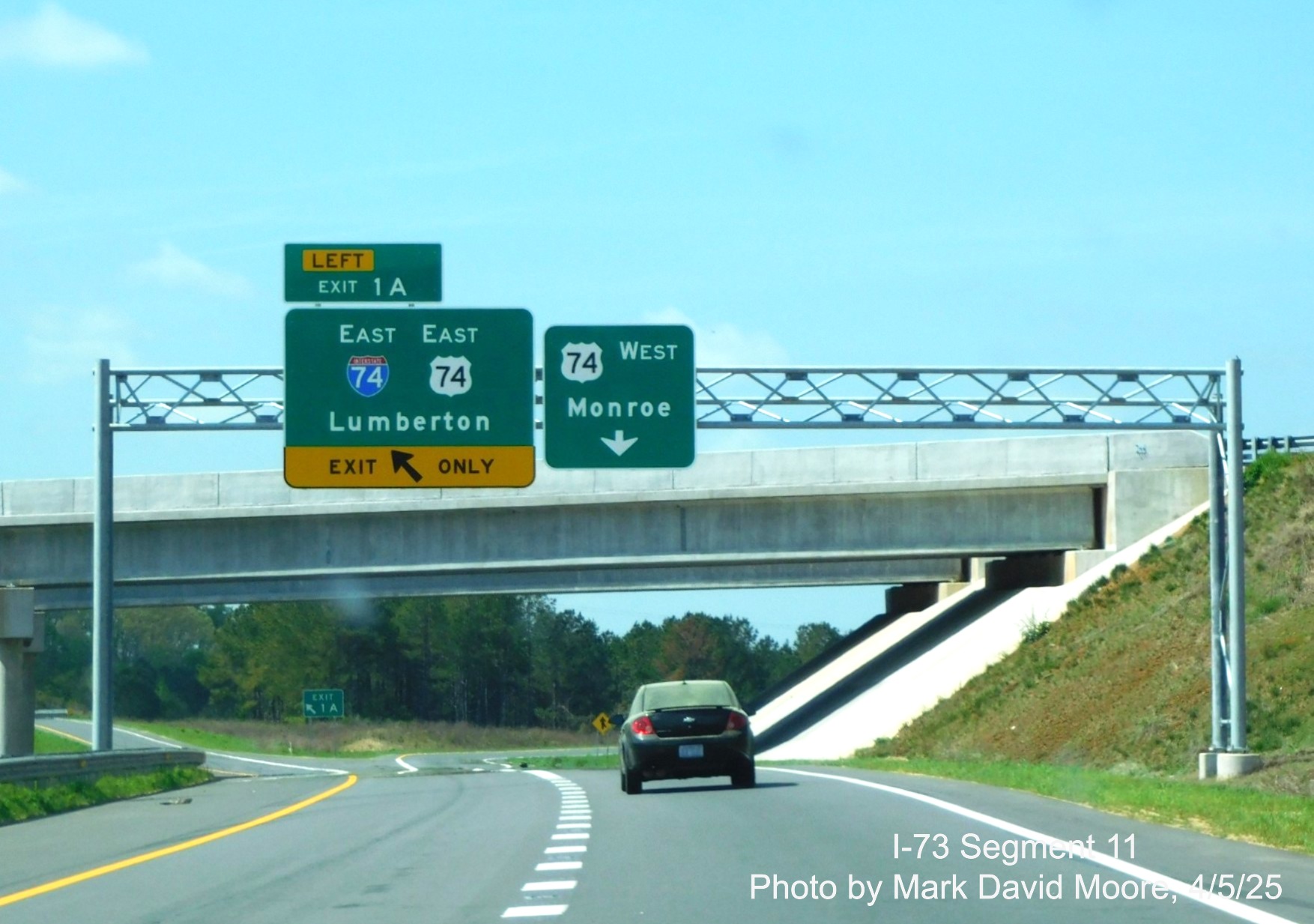 Image of overhead ramp sign for the I-74/US 74 East Rockingham Bypass
		on US 74 Business West by Mark David Moore, April 2025