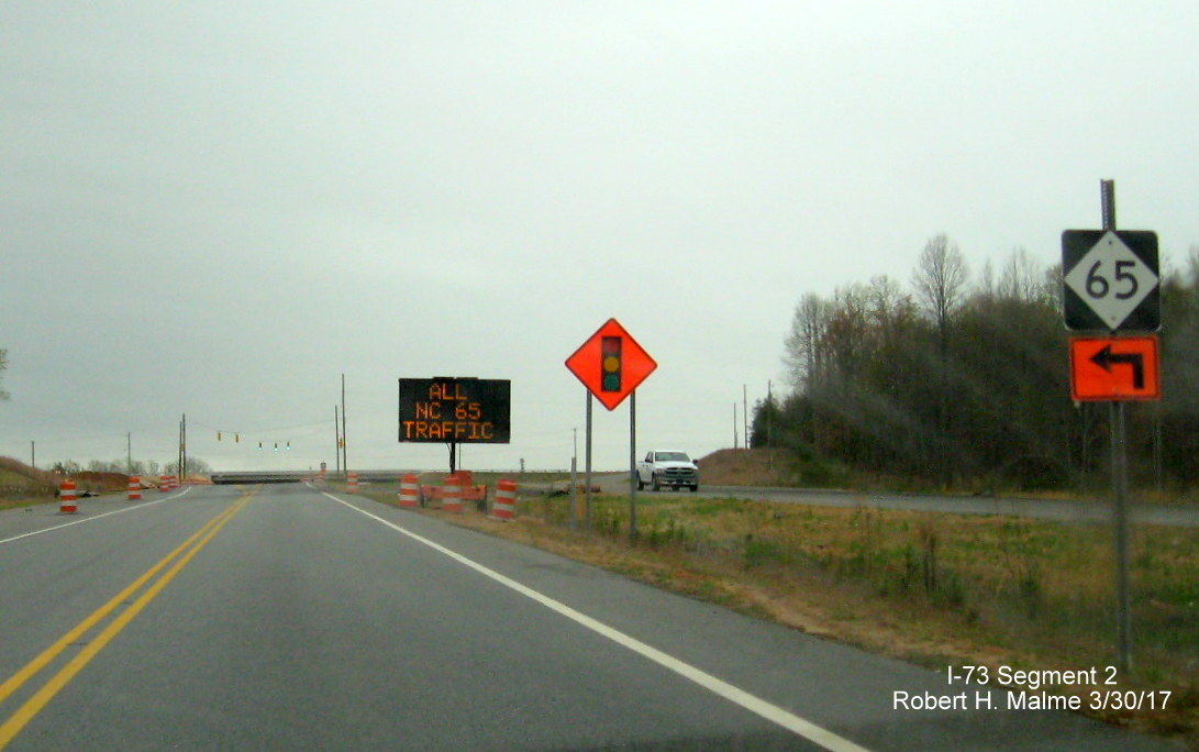 Image of view looking south along current US 220 roadway near NC 65 intersection showing temporary signage