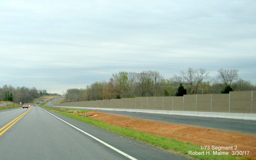 Image of view of newly erected sound barrier walls along Future I-73/US 220 South lanes in Guilford County