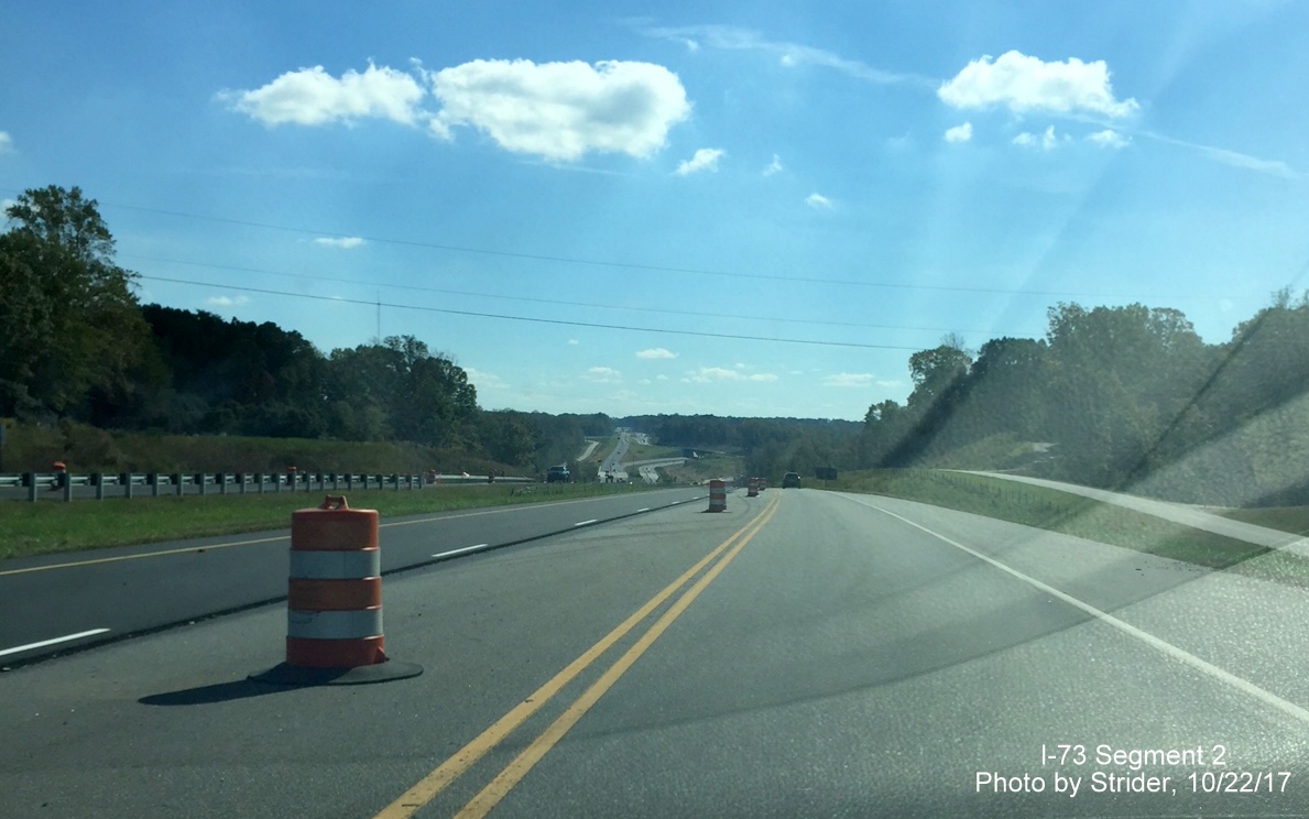 Image of US 220 South heading downhill from US 158 exit showing new pavement for I-73 South lanes being placed on roadway, by Strider