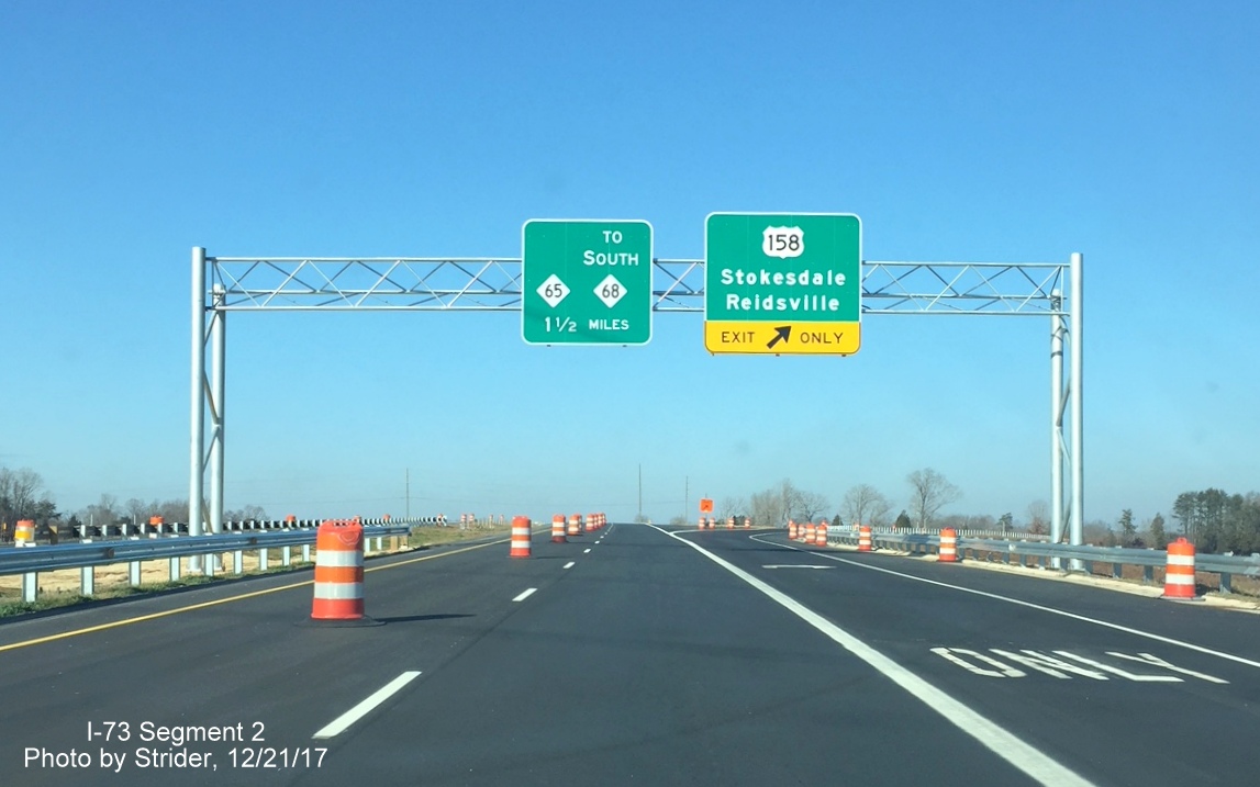 Image of newly placed overhead signs for US 158 and NC 65 exits on US 220/Future I-73 North in Stokesdale, by Strider
