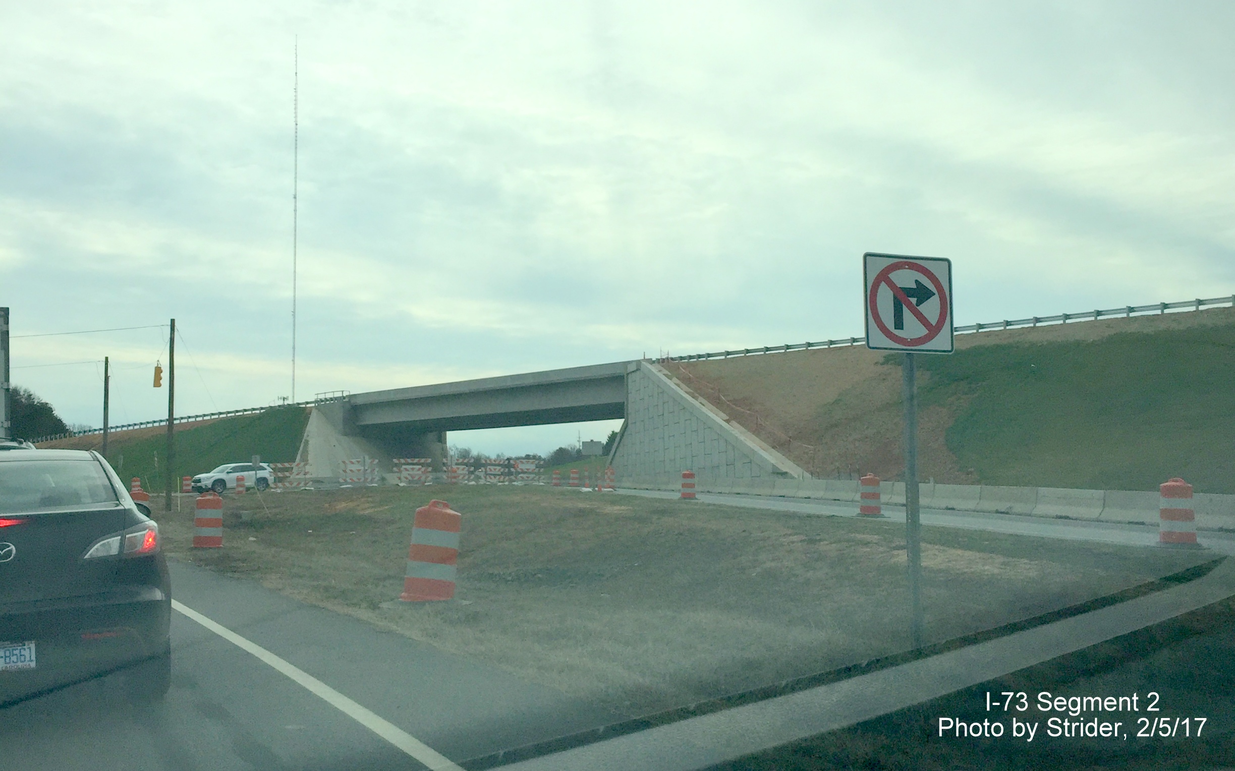 Image of closer view of future I-73/US 220 ramp over NC 68 and progress completing guardrail work, from Strider