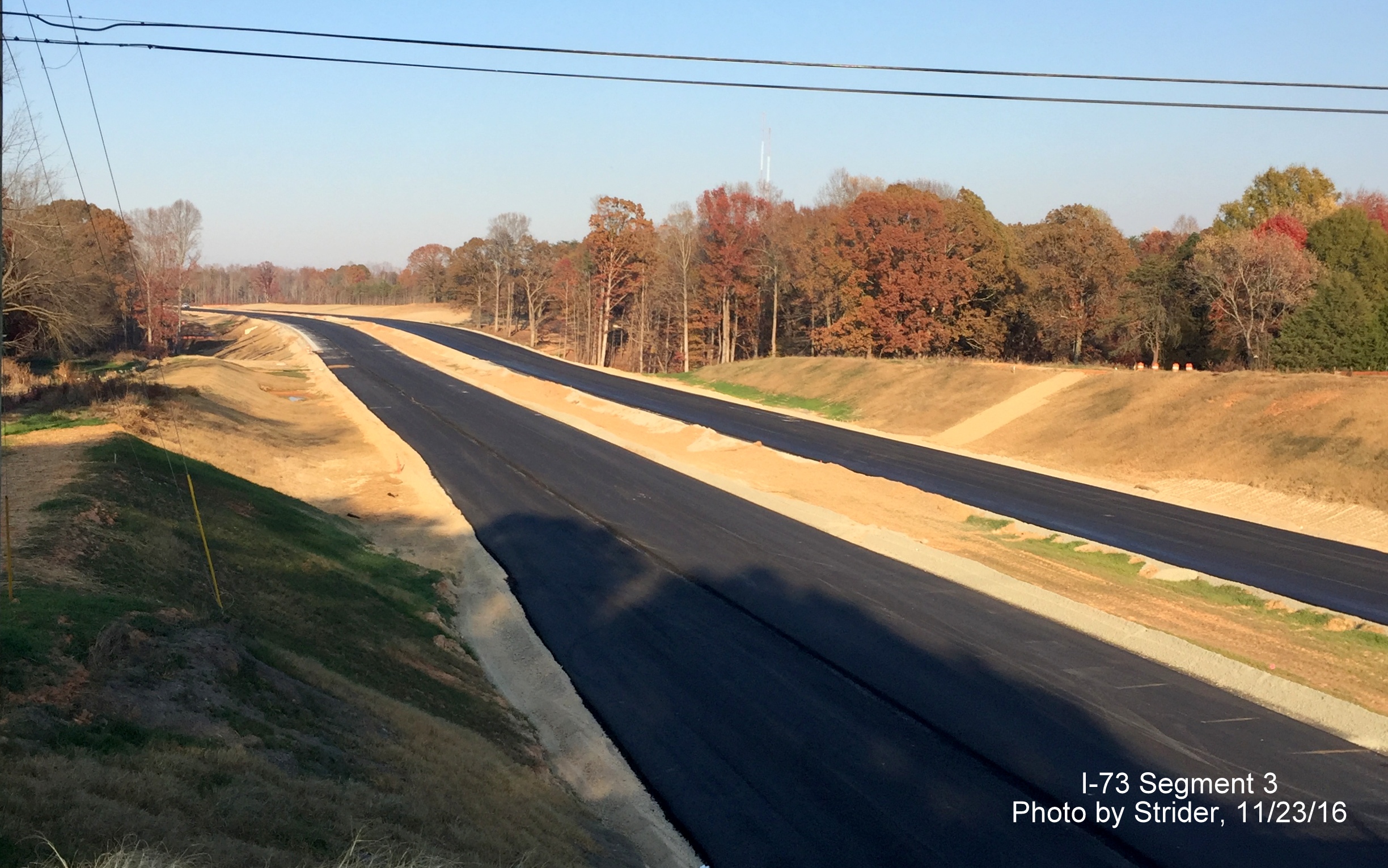 Image of view from Deboe Road bridge looking north toward US 220 showing progress in paving lanes, from Strider
