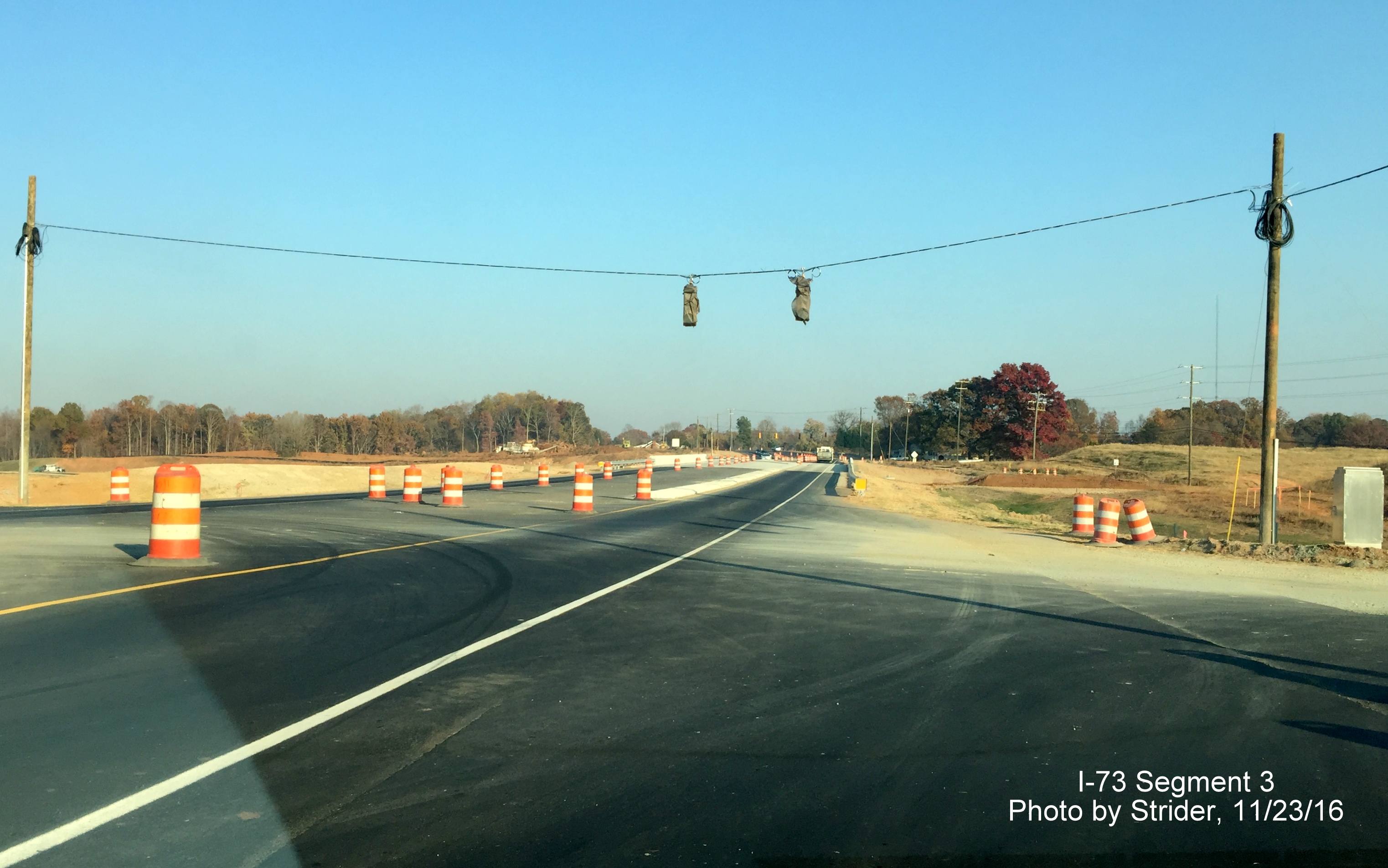 Image looking east at future ramp to I-73 South from NC 150 near Summerfield showing installation of traffic lights, from 
              Strider