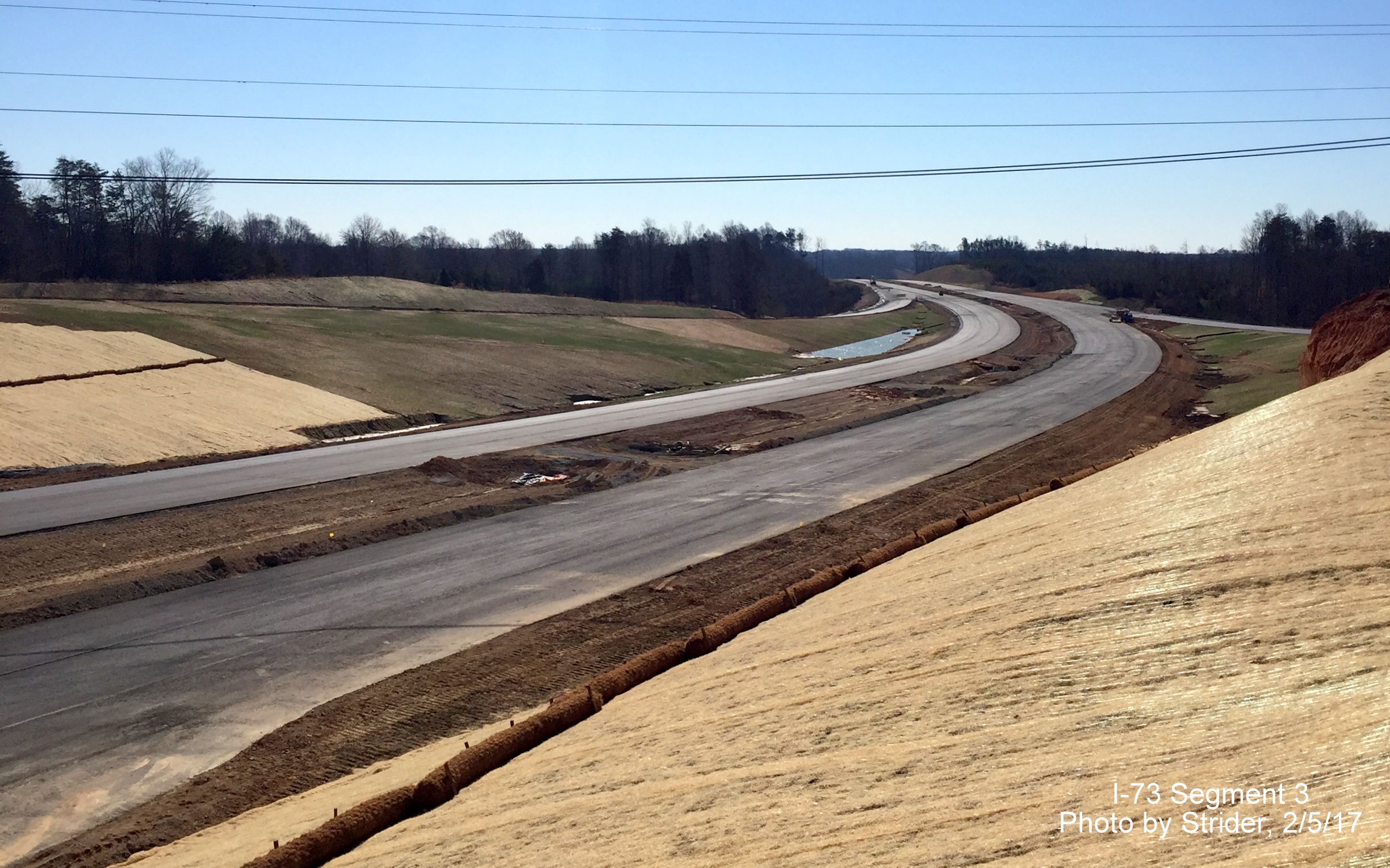 Image of view looking south from NC 150 bridge showing progress paving future I-73 lanes, from Strider