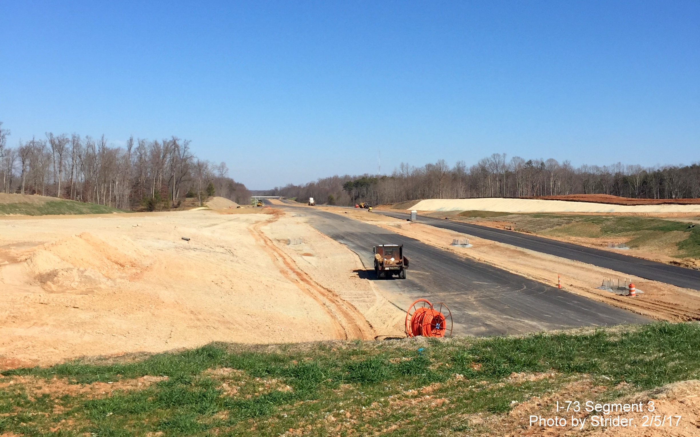 Image of view looking north from future I-73 interchange with NC 150 showing progress paving area, from Strider