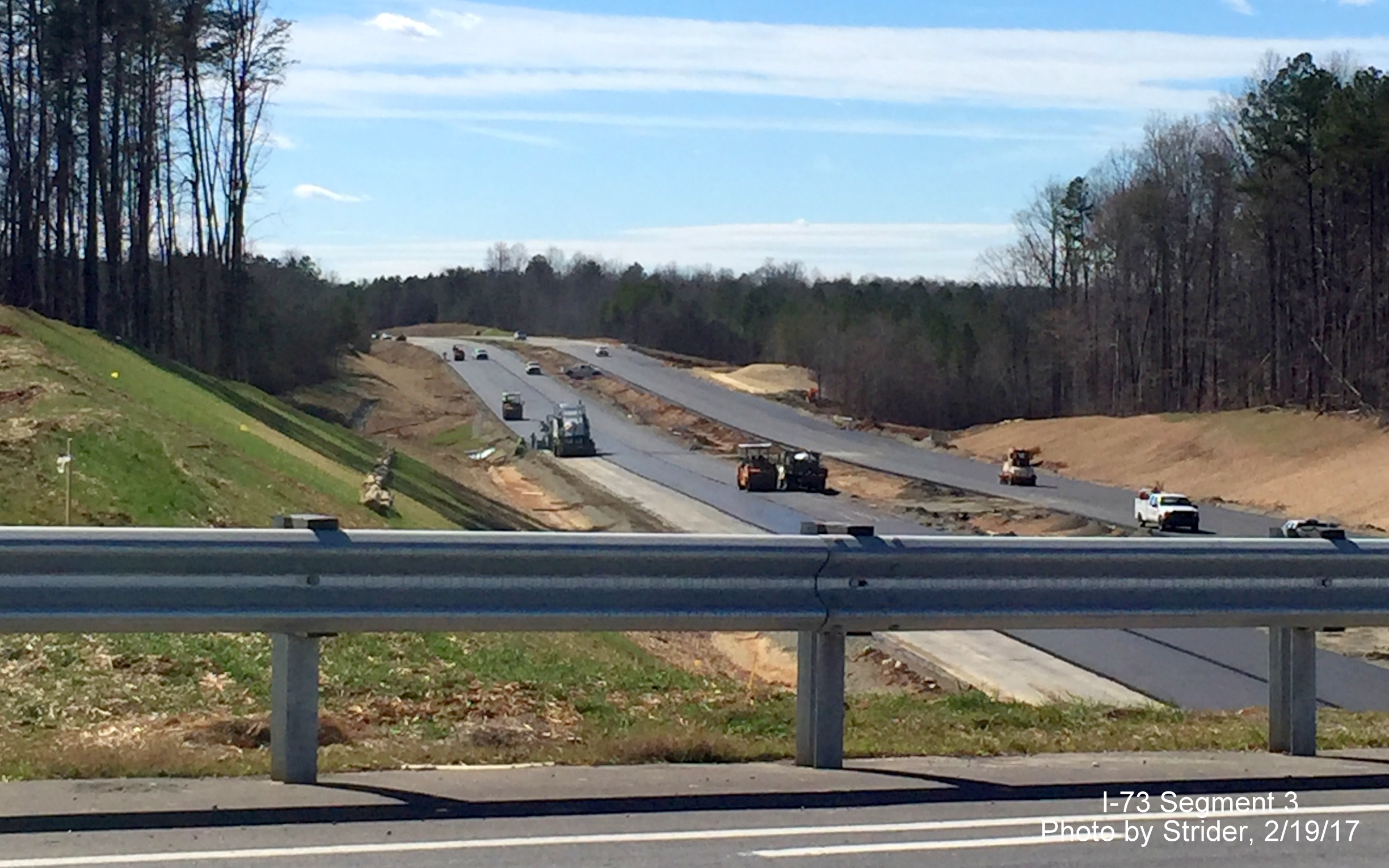 Image of view looking south from Bunch Rd bridge, showing progress in final paving of I-73 lanes, from Strider
