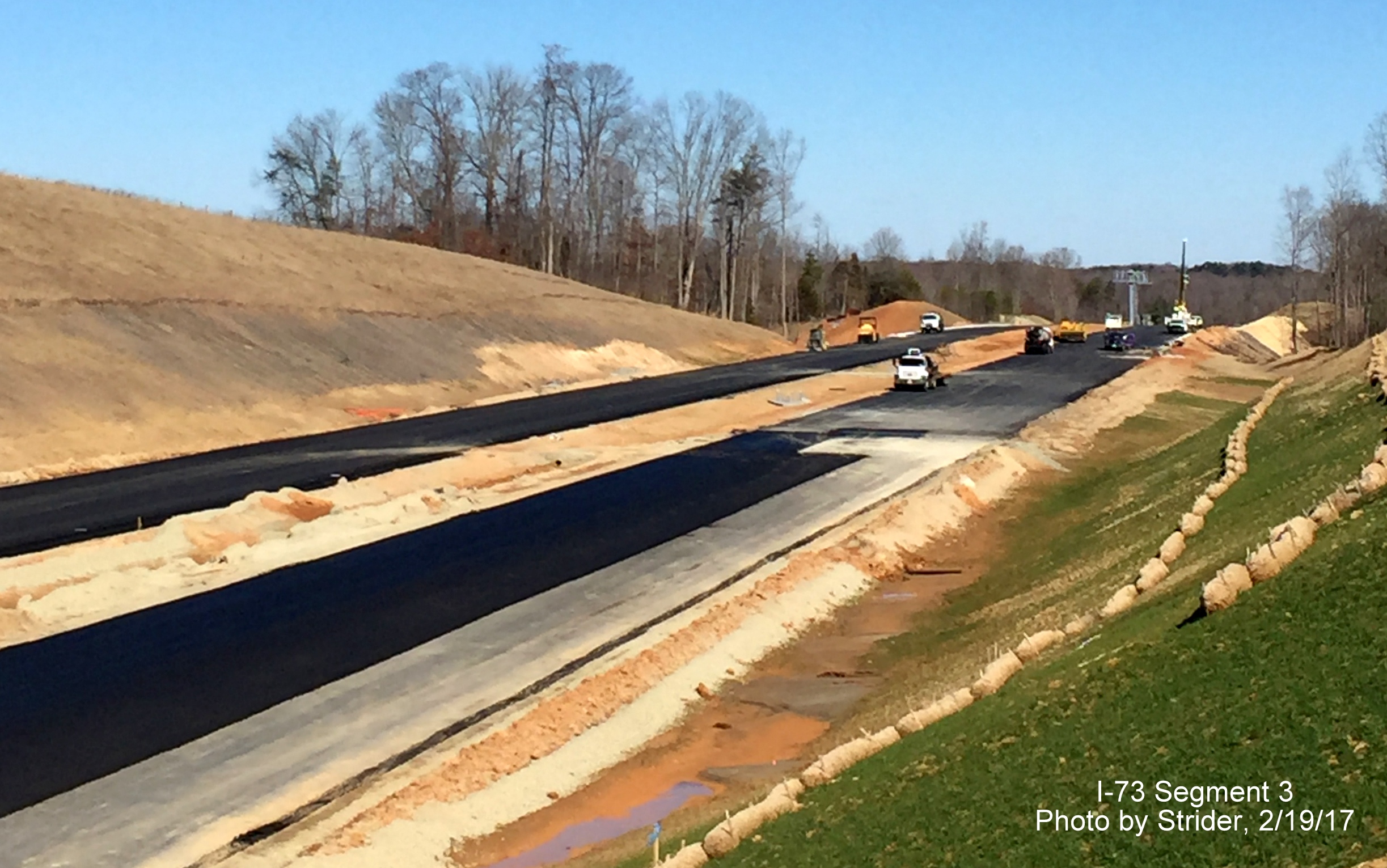 Image of view looking north from Bunch Rd bridge showing progress paving future I-73 lanes, from Strider