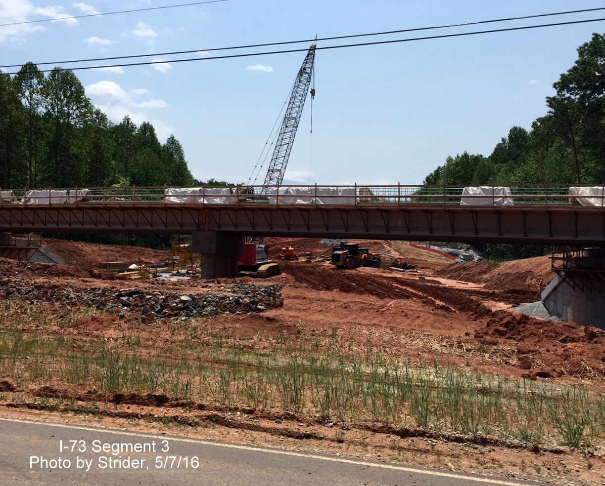 Image of construction of Deboe Rd bridge over future I-73 roadbed, from Strider
