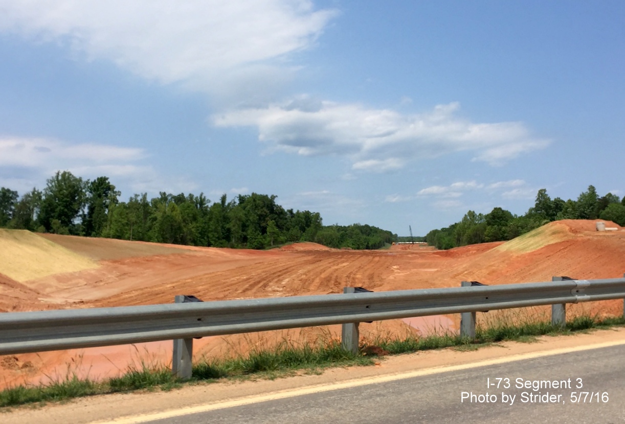 Image of new construction to the north of NC 150 for future I-73 with clearing for Deboe Rd bridge in distance, from Strider