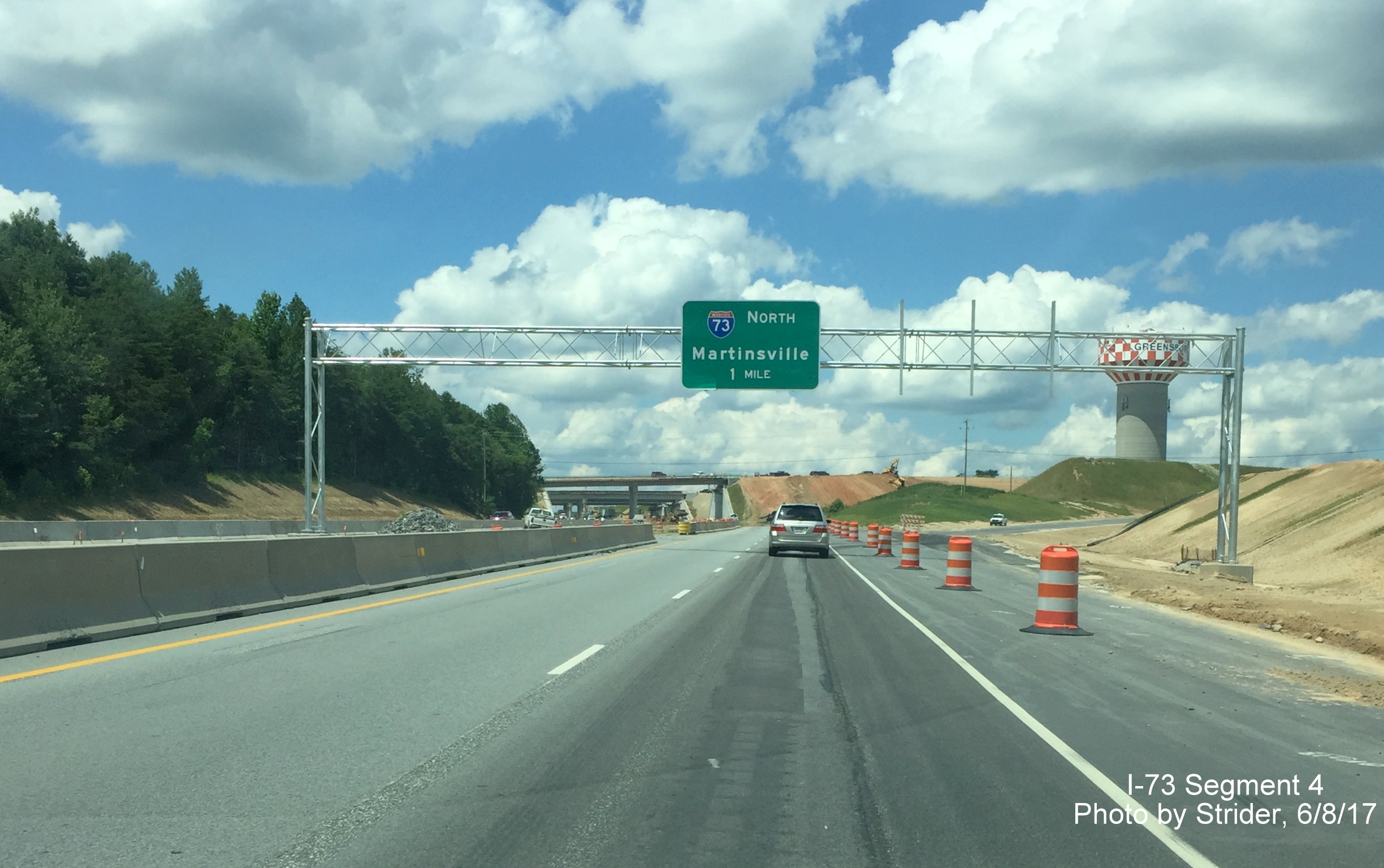 Image taken of overhead signs for I-73 interchanges with NC 68 near PTI Airport in Greensboro, from Strider