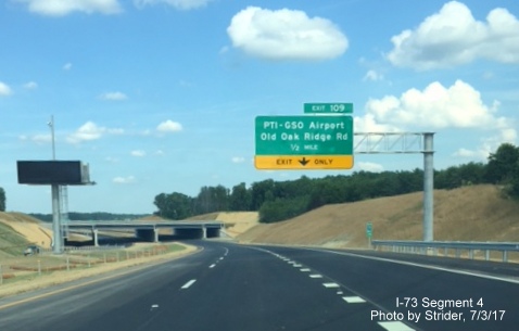 Image of new I-73 South roadway and 1/2 mile exit sign for PTI Airport in Greensboro, by Strider