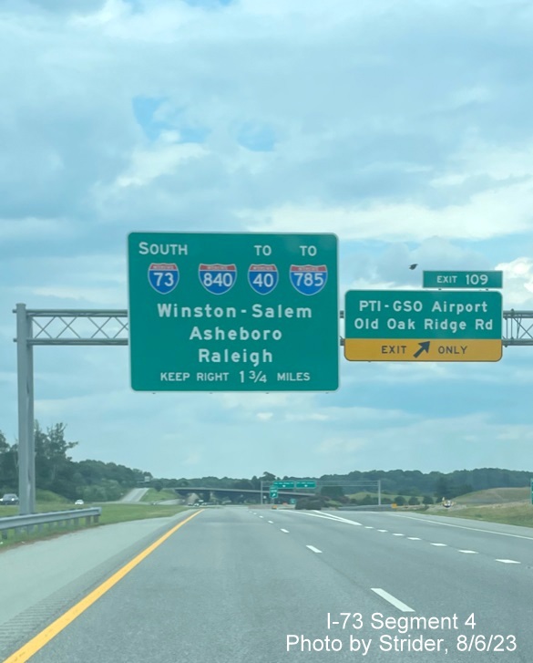 Image of 1 1/4 Mile advance sign for Greensboro Loop exit with new I-785 shield, replacing US 220 due to earlier 
        completion of Loop on I-73 South, photo by Strider, August 2023