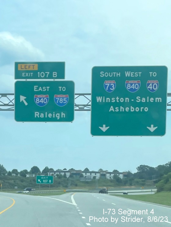 Image of overhead ramp sign for Greensboro Loop exit north with new I-785 shield and Raleigh control
        city due to earlier completion of Loop on I-73 South, photo by Strider, August 2023